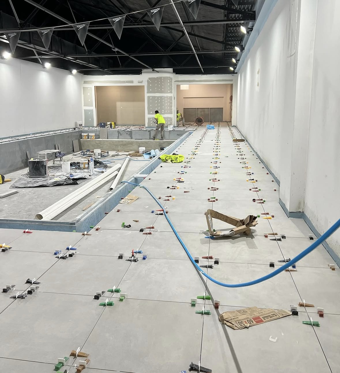 Large commercial floor during tile installation